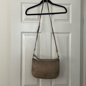 Coach taupe colored cross body handbag.